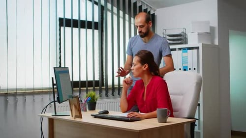 Coworkers Discussing Work at a Computer