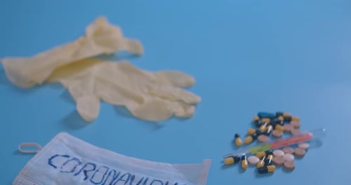 Medical Supplies with Coronavirus Face Mask on Blue