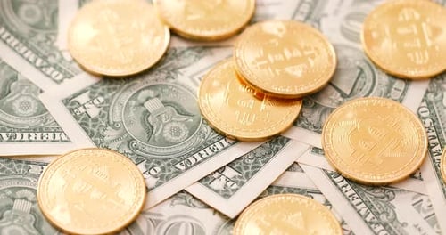 Golden Bitcoin Coins on American Dollar Bills