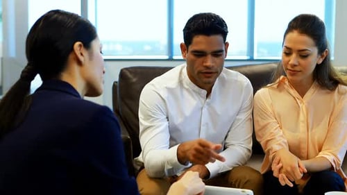 Business Team Discussing Plans on Tablet in Modern Office