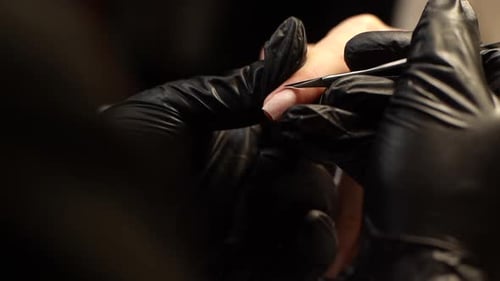Manicurist Working on Client Nails with Precision