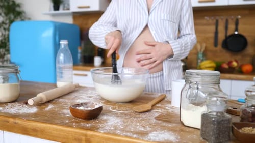 Pregnant Woman Mixing Batter in Kitchen at Home