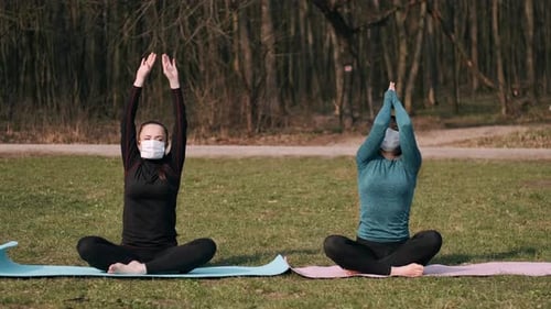 Two Women Exercising Outdoors Wearing Face Masks