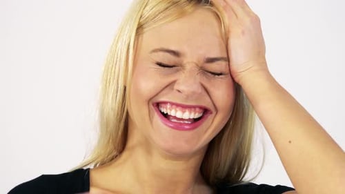 A Young Attractive Woman Makes Goofy Faces at the Camera - Face Closeup - White Screen Studio