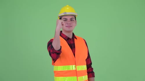 Young Man Construction Worker Motivates with Fist Pump