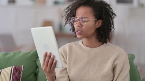 Young Woman Browsing Tablet at Home