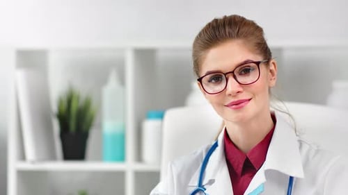 Young Woman Doctor Smiling with Stethoscope in Office