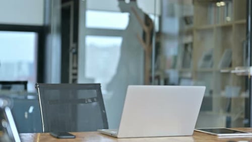 Young Man Working On Laptop At Desk