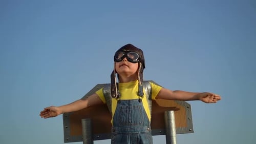 Child Dressed As Pilot With Cardboard Wings