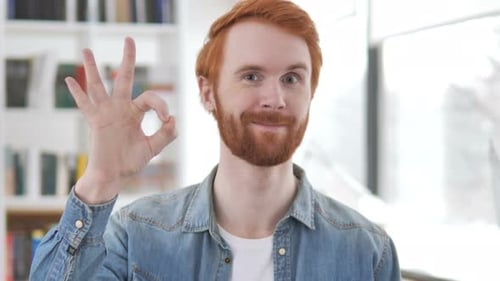 Smiling Adult Man Gestures Okay Sign Indoors