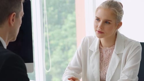 Business Professionals Meeting to Review Documents in Office