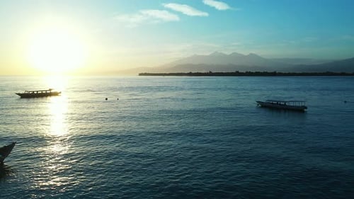 Wide birds eye travel shot of a white sand paradise beach and aqua blue water background in high res