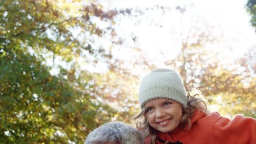 Happy Father and Daughter Play in Autumn Park
