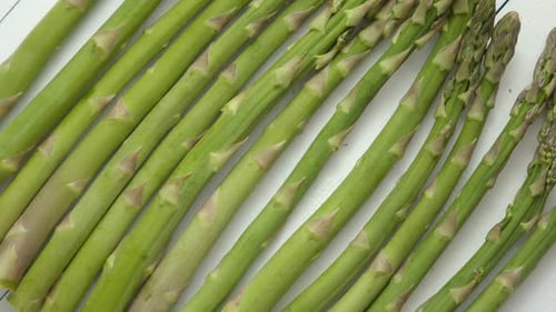 Green Fresh and Healrhy Asparagus Placed on a White Wooden Table. Top View. Close Up.