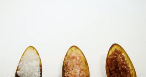 Various types of sea salt in a spoon 4k