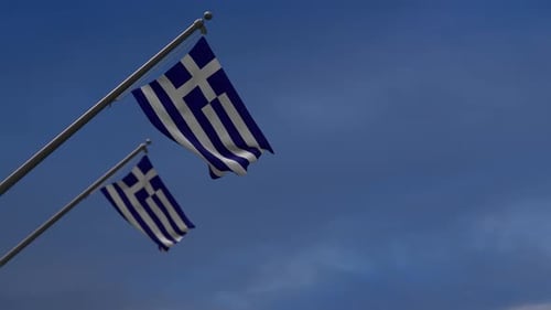Realistic Greek Flag Waving Against a Clear Blue Sky