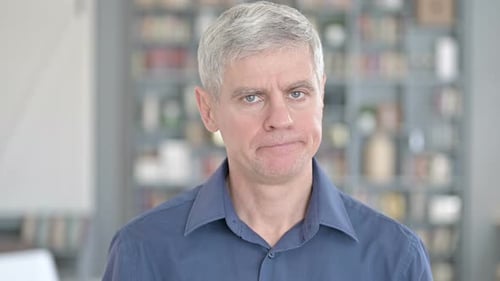 Mature Adult with Gray Hair Looks at Camera