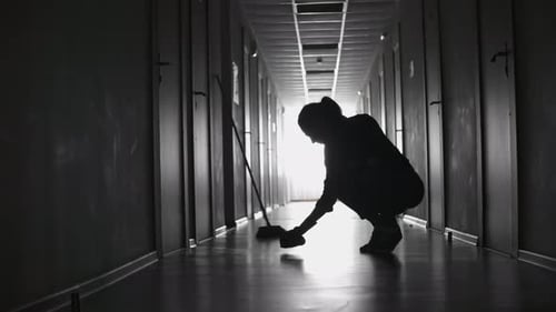 Tired Female Cleaner Scrubbing Floor