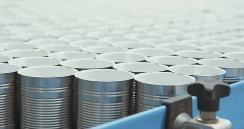 Metal Cans Moving Along Conveyor Belt in Factory