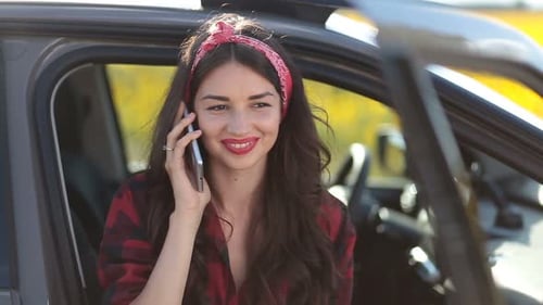 Smiling Woman Talking on Phone in Car, Rural Setting