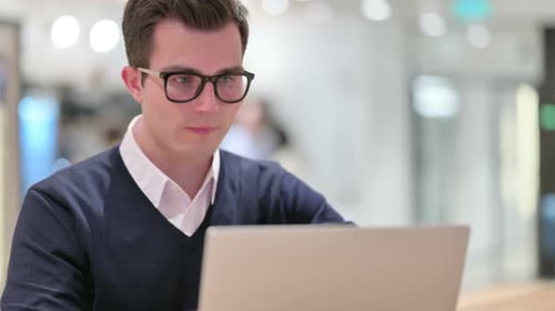Man Working on Laptop in Office