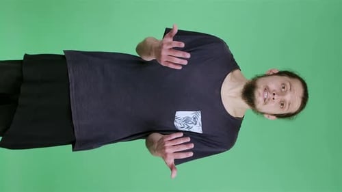 A Portrait of a Young Man Looking at the Camera Waving His Hands Indignantly Putting His Hands to