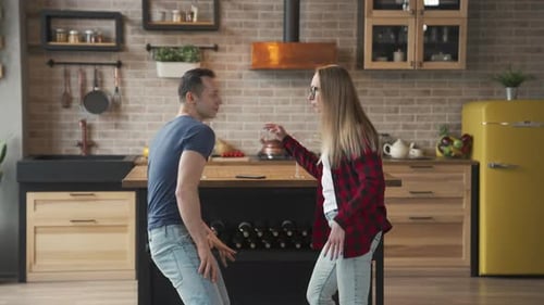 Couple Dancing Playfully in a Modern Kitchen