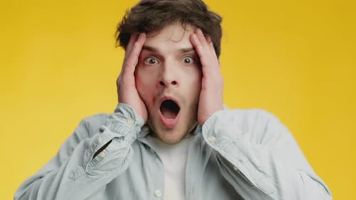 Man Reacts with Surprise and Shock on Yellow