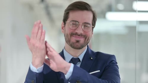Man in Suit Clapping in Office