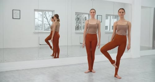 Two Young Dancers Are Rehearsing Their Perfomance in the White Bright Dance Hall Ballet Rehearsal