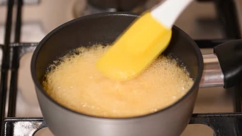 Golden Liquid Bubbling in a Saucepan