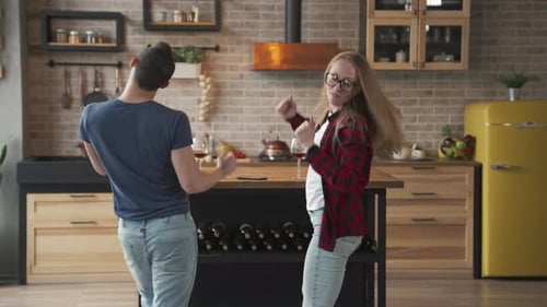 Couple Dancing in their Kitchen with Wine