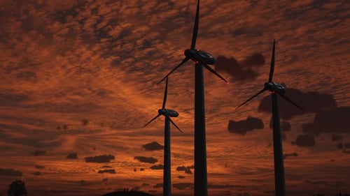 windbetriebene Stromerzeuger vor dem Himmel bei Sonnenuntergang