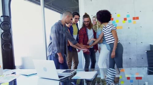 Diverse Team Joins Hands in Celebration