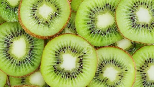 Green Kiwi Rotating Top View Fresh and Ripe Sweet Fruits Circles