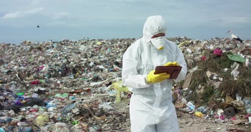 Scientist Examining Data at a Landfill