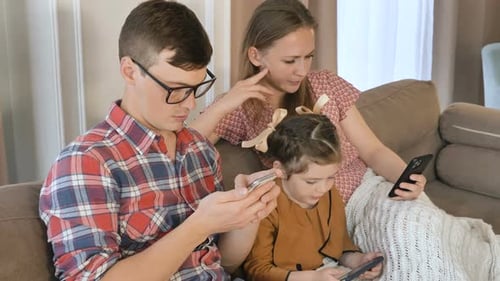 Family Using Phones Together at Home