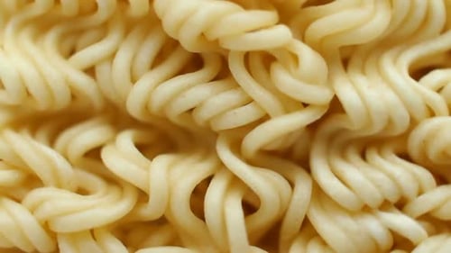 Instant Noodles Close Up. Front of the Camera Rotates Plate with Noodles