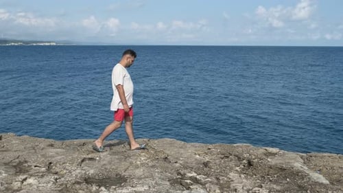 Man Walking Near Sea