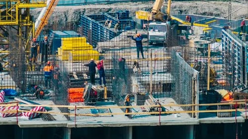 Busy Construction Site with Workers and Heavy Equipment