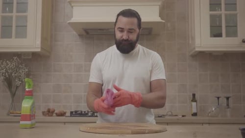 Man Cleaning Cutting Board in Home Kitchen