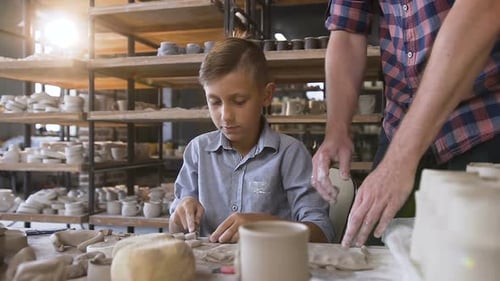 Boy Working with Clay in Pottery Studio
