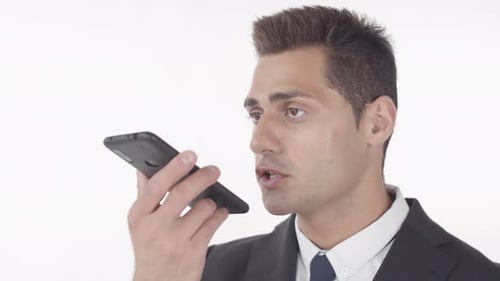 Young Adult Man Records Message on Smartphone