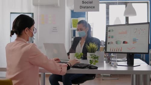 L'équipe de l'entreprise examine les Graphiques financiers tout en travaillant sur ordinateur