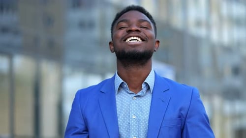 Happy Young Man Grateful in City