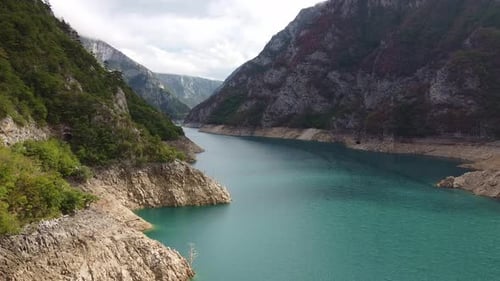 Flight Over Azure River Between Mountain Ranges