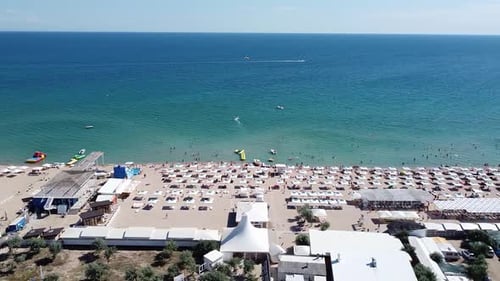 Beautiful Bird'seye View of the Coastline with a Sandy Beach White Sand Canopies on a Summer Day