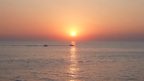 Boats Cruising on the Ocean at Sunrise