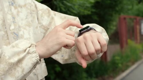 Man Using Smart Watch Device Outdoors Close Up