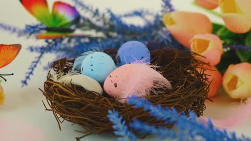 Pastel Easter Eggs in Nest With Spring Decorations
